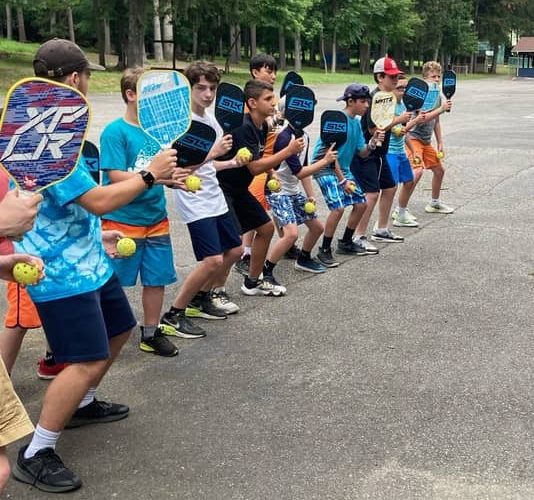 a group of people standing in a parking lot